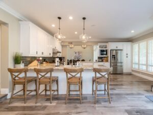 Bright, spacious kitchen with white cabinets and granite countertops.